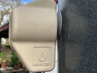 A valve cosy covering the valve of a heat pump hot water system to prevent heat loss.